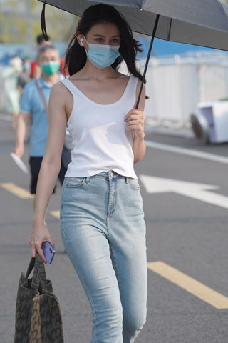 撑伞的牛仔裤美女